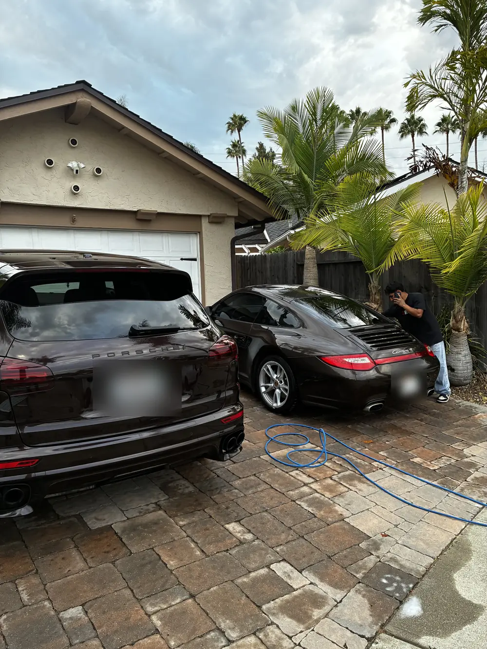 Black Porsche Cayenne and 911 after a Steb's Bravo detail, parked on a Santa Barbara driveway